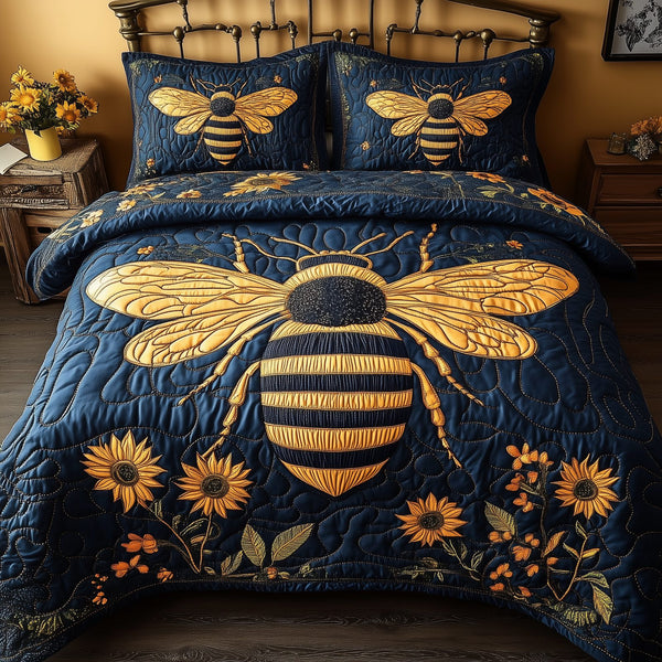 Bee Positive quilted 3-piece bedding set on a made bed with two matching pillow shams