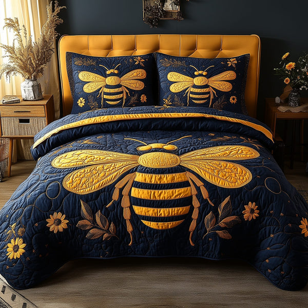Bee Positive quilted 3-piece bedding set on a made bed with two matching pillow shams