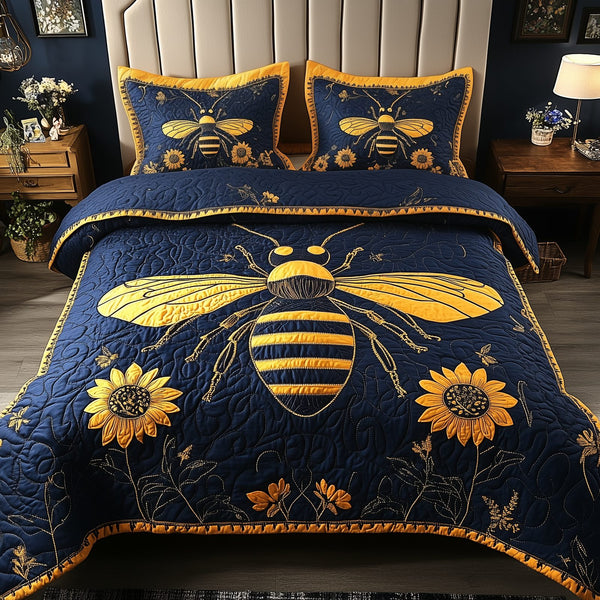 Bee Positive quilted 3-piece bedding set on a made bed with two matching pillow shams