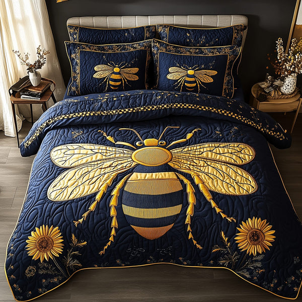 Bee Positive quilted 3-piece bedding set on a made bed with two matching pillow shams