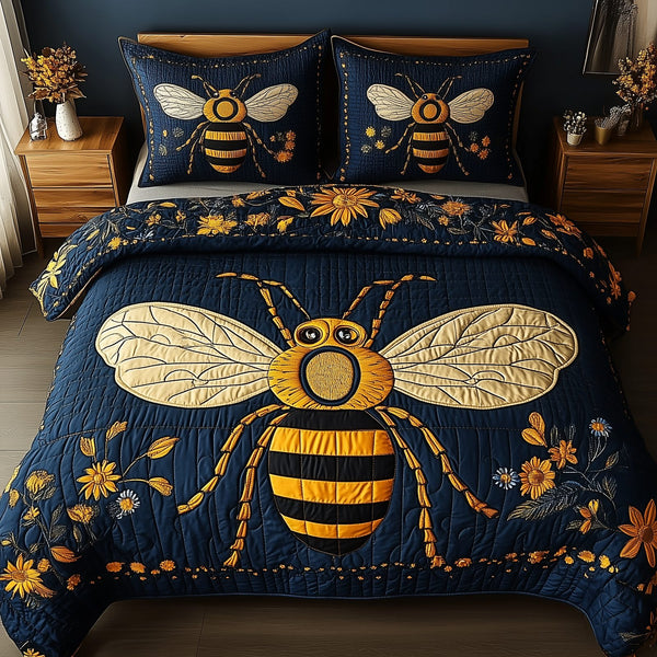 Bee Positive quilted 3-piece bedding set on a made bed with two matching pillow shams