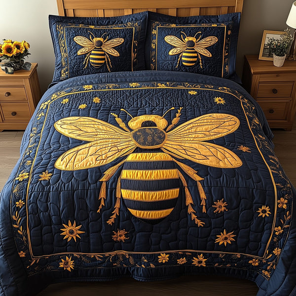Bee Positive quilted 3-piece bedding set on a made bed with two matching pillow shams