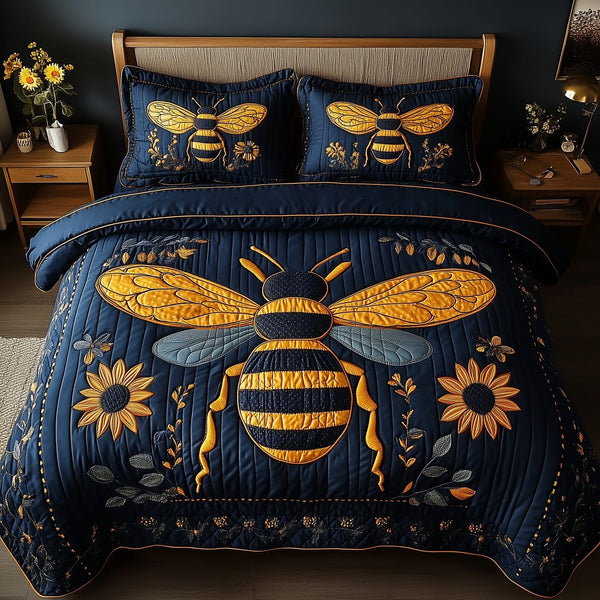 Bee Positive quilted 3-piece bedding set on a made bed with two matching pillow shams