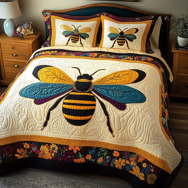 Bee Positive quilted 3-piece bedding set on a made bed with two matching pillow shams