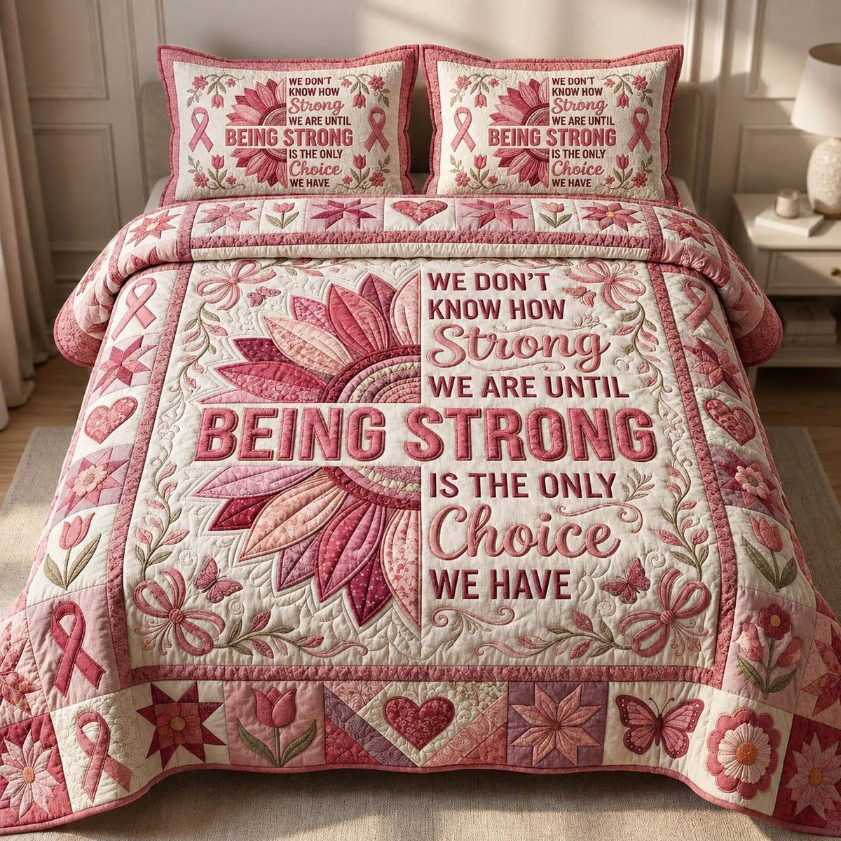 Being Strong quilted 3-piece bedding set on a made bed with two matching pillow shams