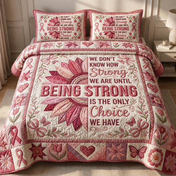 Being Strong quilted 3-piece bedding set on a made bed with two matching pillow shams