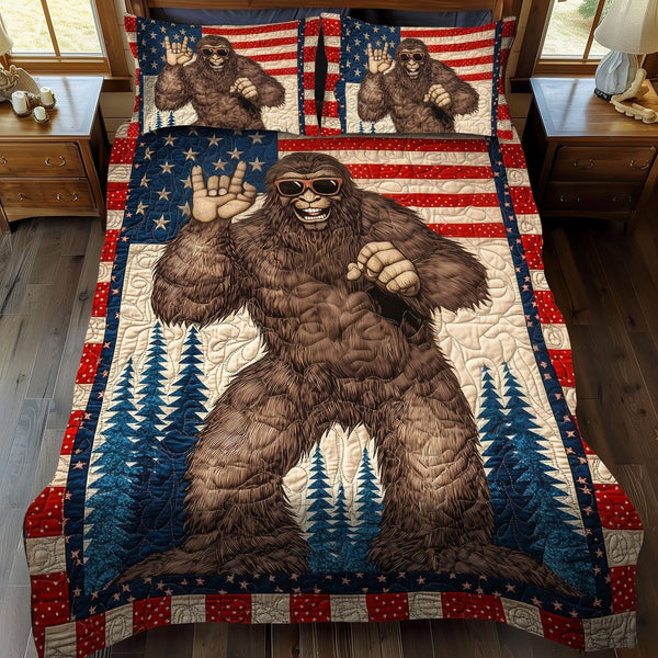 Bigfoot and the Flag quilted 3-piece bedding set on a made bed in a warmly lit bedroom