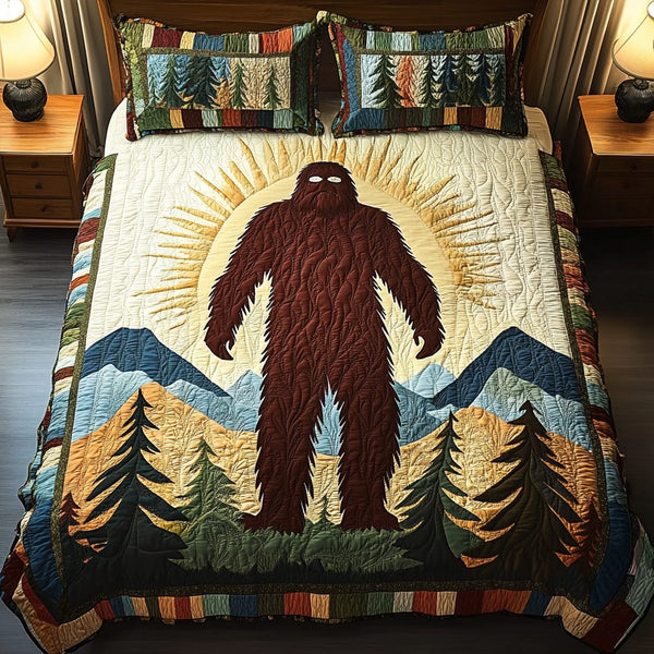 Bigfoot Mountain Glow quilted 3-piece bedding set on a made bed with two matching pillow shams