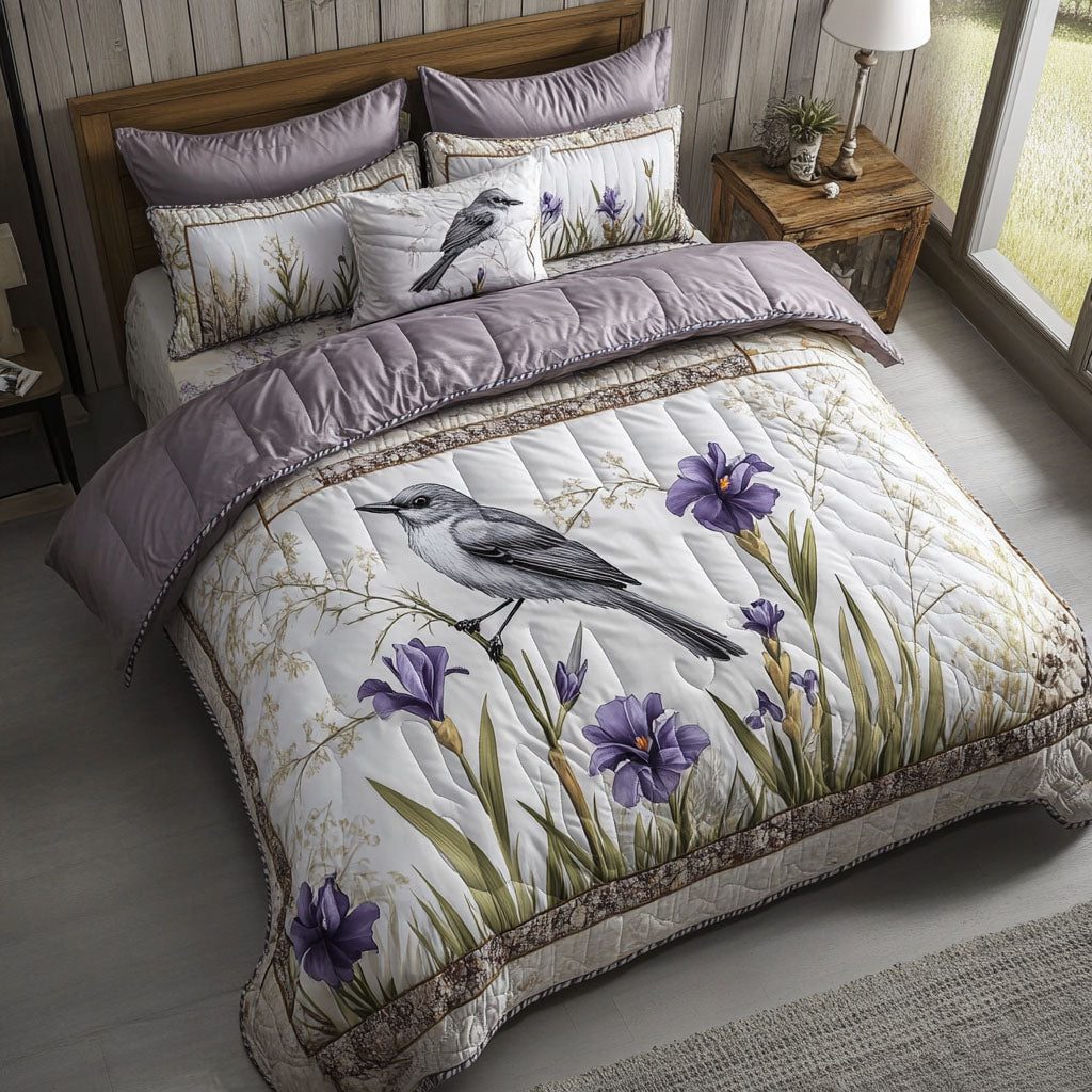 Birdsong Blooms quilted 3-piece bedding set on a made bed with two matching pillow shams