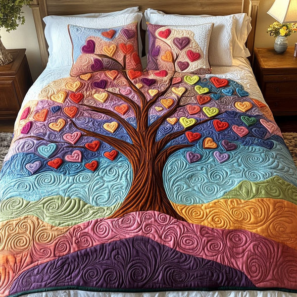 Bliss Bloom quilted 3-piece bedding set on a made bed with two matching pillow shams