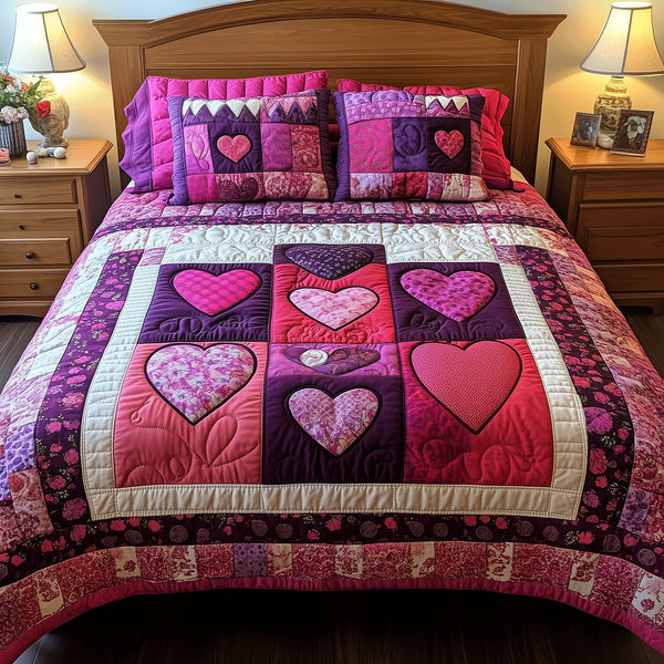 Blissful Hearts quilted 3-piece bedding set on a made bed with two matching pillow shams