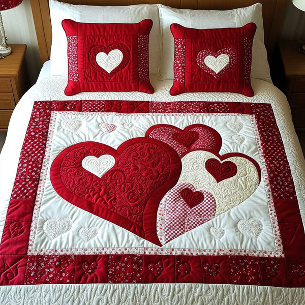 Blissful Hearts quilted 3-piece bedding set on a made bed with two matching pillow shams