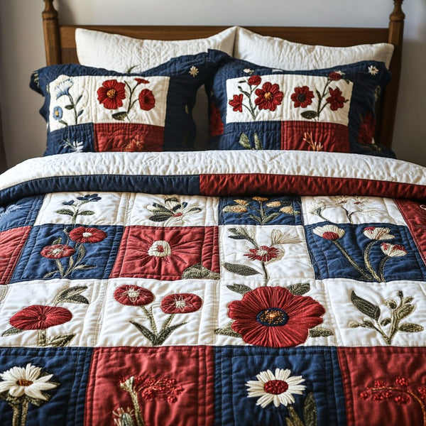 Bloom Bliss quilted 3-piece bedding set on a made bed with two matching pillow shams