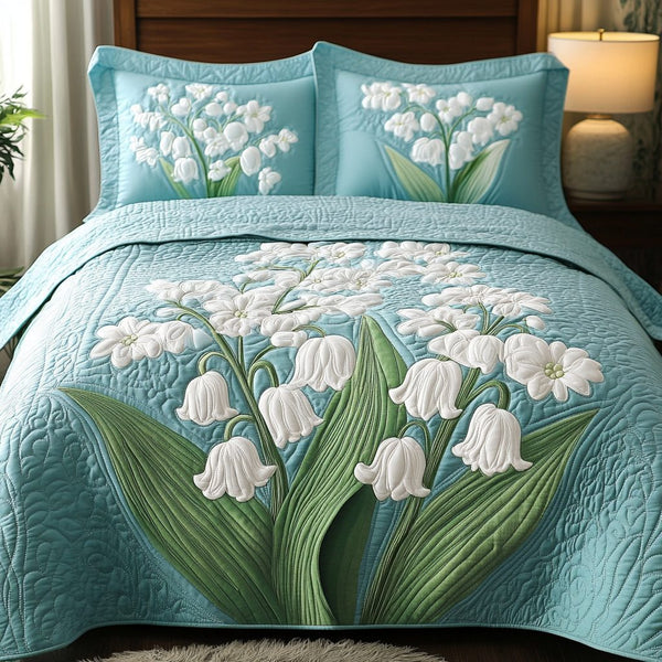 Bloom Charm quilted 3-piece bedding set on a made bed with two matching pillow shams