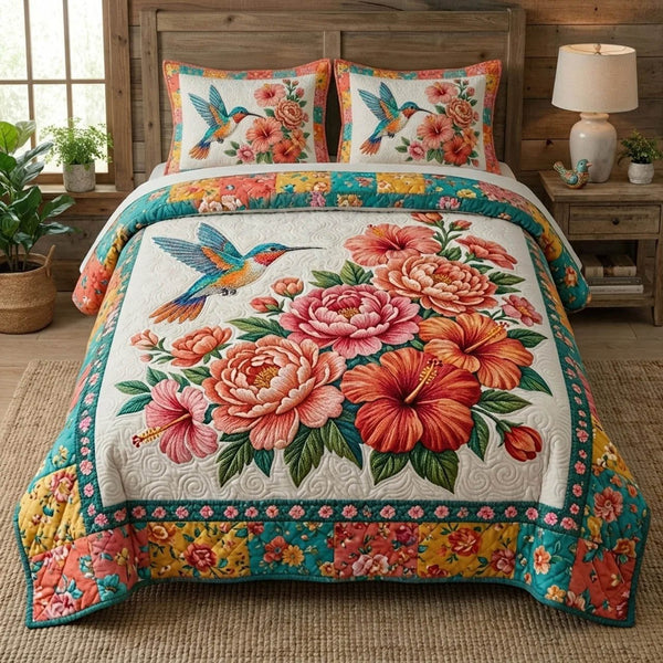 Bloom Garden quilted 3-piece bedding set on a made bed with two matching pillow shams