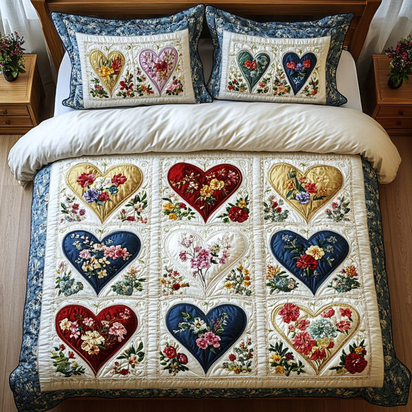 Blooming Hearts quilted 3-piece bedding set on a made bed with two matching pillow shams