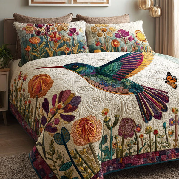 Blooming Wings quilted 3-piece bedding set on a made bed with two matching pillow shams