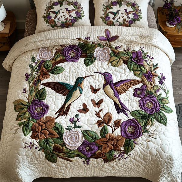 Blooming Wings quilted 3-piece bedding set on a made bed with two matching pillow shams