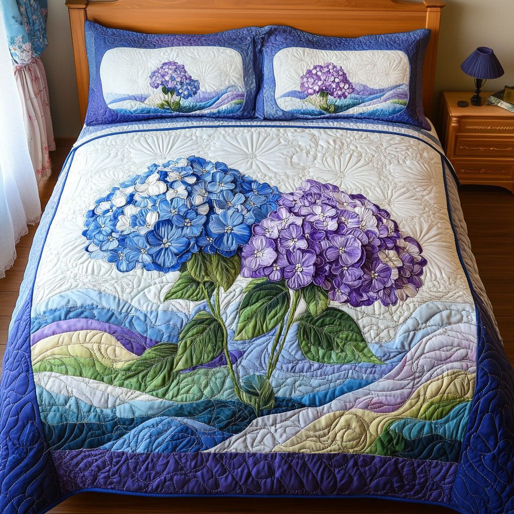 Blossom Dreams quilted 3-piece bedding set on a made bed with two matching pillow shams