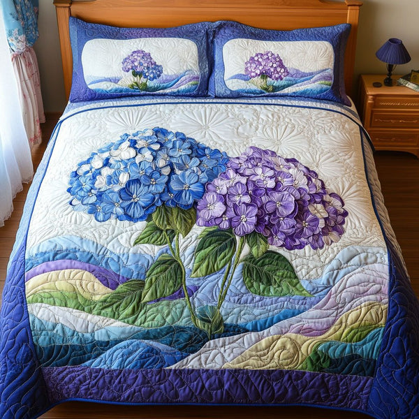 Blossom Dreams quilted 3-piece bedding set on a made bed with two matching pillow shams