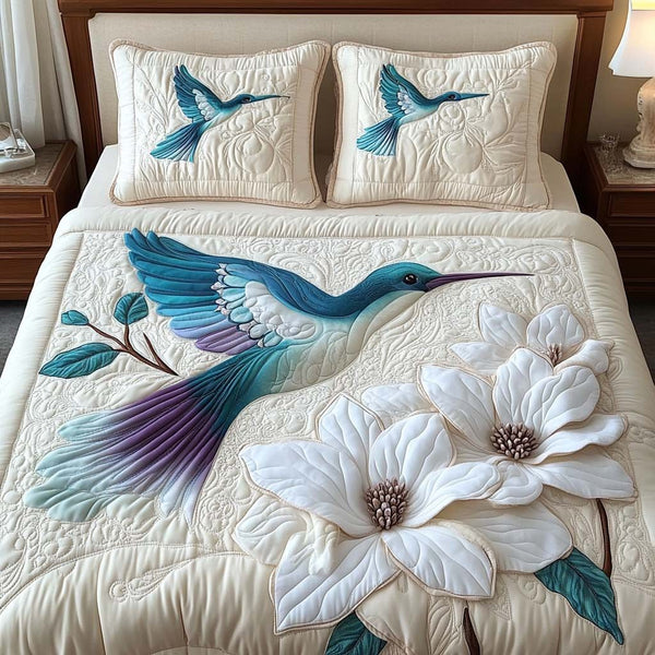 Blossom Flight quilted 3-piece bedding set on a made bed with two matching pillow shams