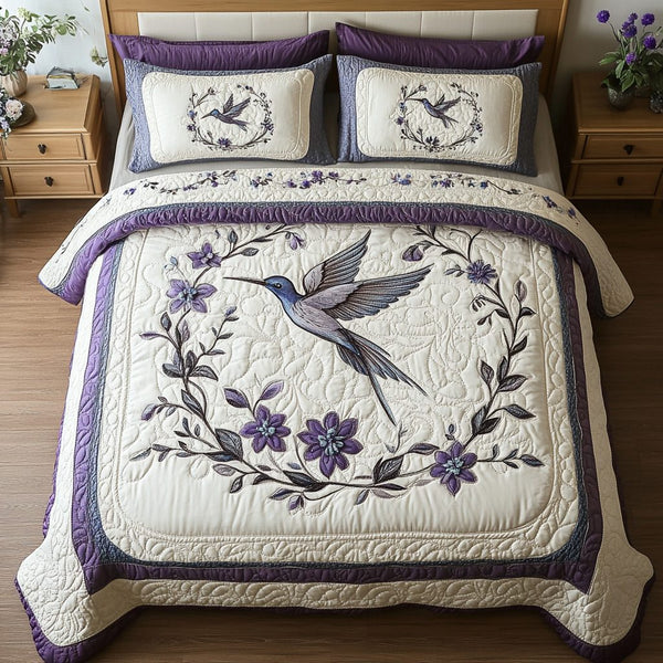 Blossom Flight quilted 3-piece bedding set on a made bed with two matching pillow shams