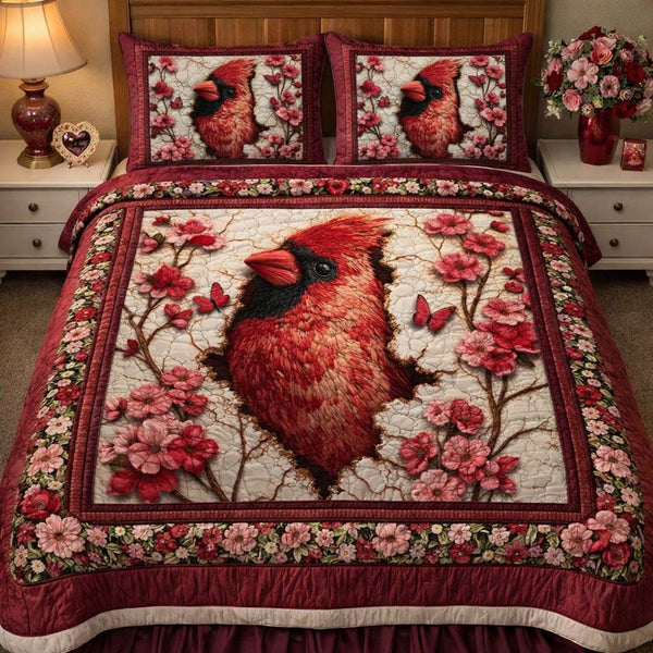 Blossom Heart Cardinal quilted 3-piece bedding set on a made bed with two matching pillow shams