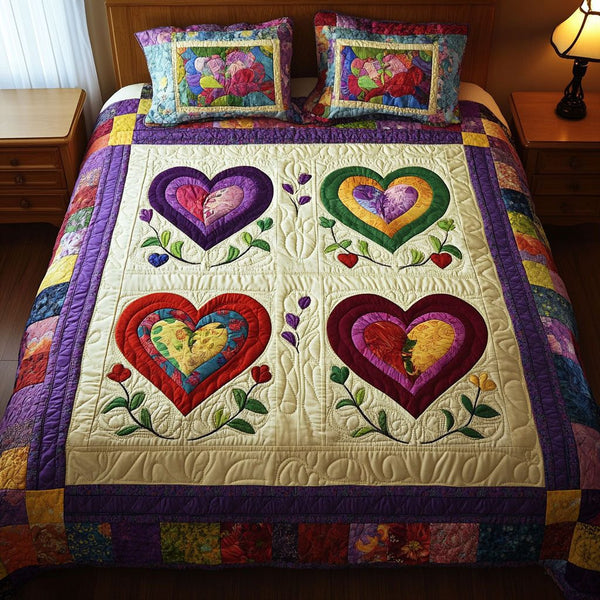 Blossom Hearts quilted 3-piece bedding set on a made bed with two matching pillow shams