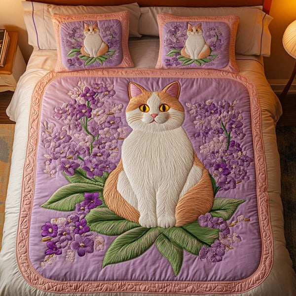 Blossom Kitty quilted 3-piece bedding set on a made bed with two matching pillow shams