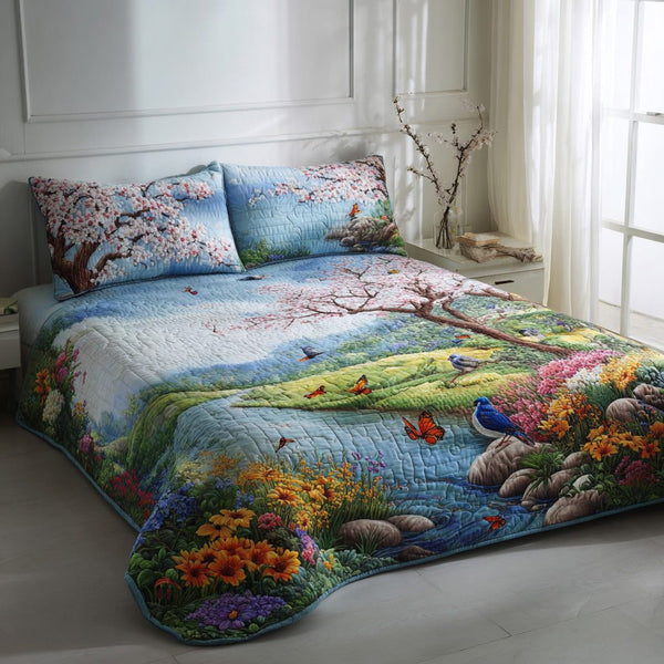 Blossom Stream quilted 3-piece bedding set on a made bed with two matching pillow shams
