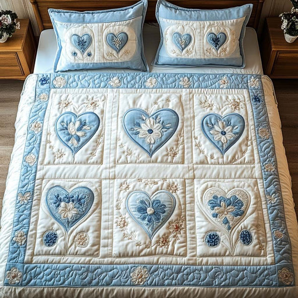 Blue Bloom quilted 3-piece bedding set on a made bed with two matching pillow shams