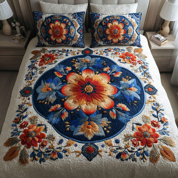 Blue Bloom quilted 3-piece bedding set on a made bed with two matching pillow shams