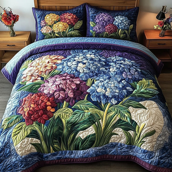 Blue Elegance quilted 3-piece bedding set on a made bed with two matching pillow shams