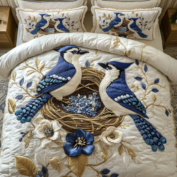 Blue Feather quilted 3-piece bedding set on a made bed with two matching pillow shams
