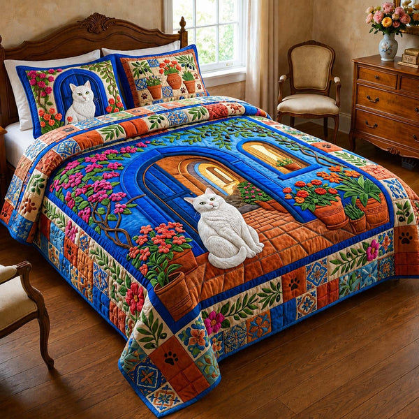 Blue Garden Cat quilted 3-piece bedding set on a made bed with two matching pillow shams