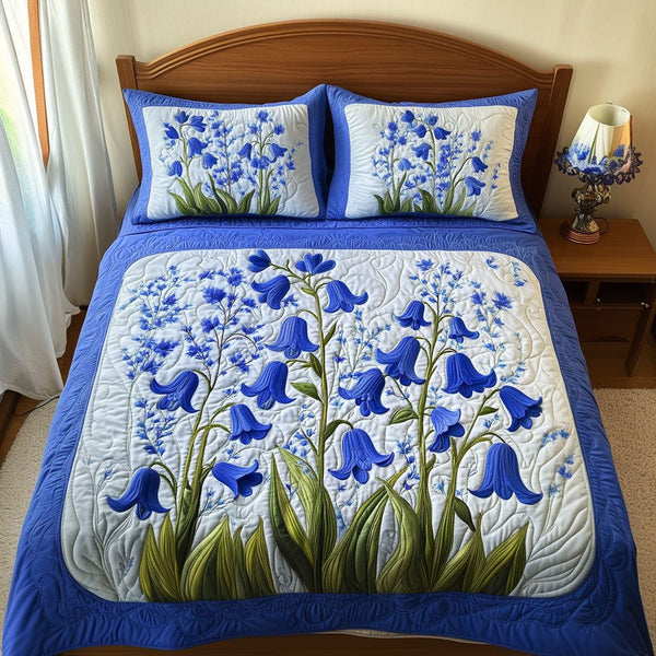 Blue Garden Melody quilted 3-piece bedding set on a made bed with two matching pillow shams