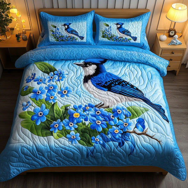 Blue Haven quilted 3-piece bedding set on a made bed with two matching pillow shams