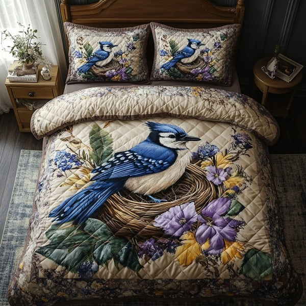 Blue Jay Serenade quilted 3-piece bedding set on a made bed with two matching pillow shams