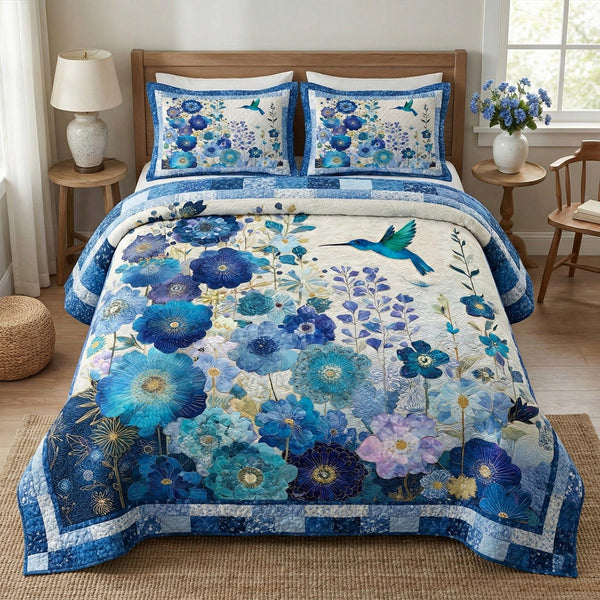 Blue Meadow quilted 3-piece bedding set on a made bed with two matching pillow shams