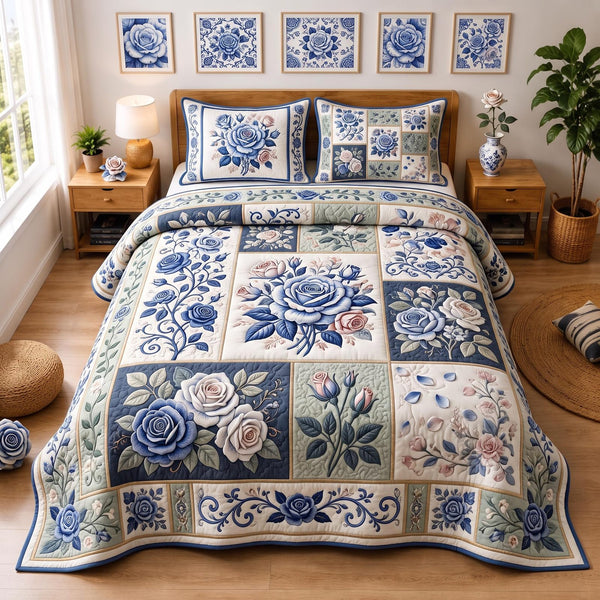 Blue Rose Garden quilted 3-piece bedding set on a made bed with two matching pillow shams