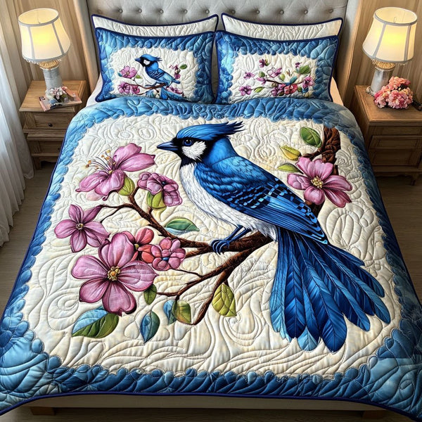 Blue Sky Blooms quilted 3-piece bedding set on a made bed with two matching pillow shams