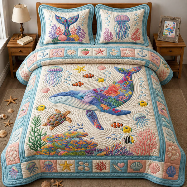 Blue Whale quilted 3-piece bedding set on a made bed in a light coastal bedroom