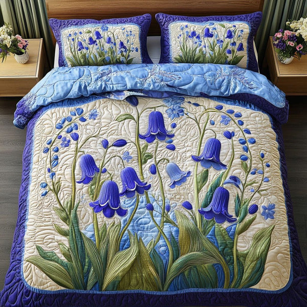 Bluebell Charm quilted 3-piece bedding set on a made bed with two matching pillow shams