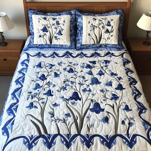 Bluebell Whispers quilted 3-piece bedding set on a made bed with two matching pillow shams
