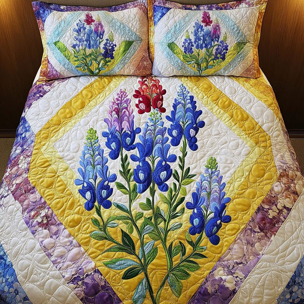 Bluebonnet Beauty quilted 3-piece bedding set on a made bed with two matching pillow shams