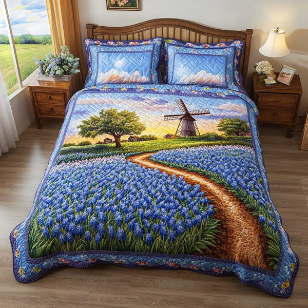 Bluebonnet Bliss quilted 3-piece bedding set on a made bed with two matching pillow shams