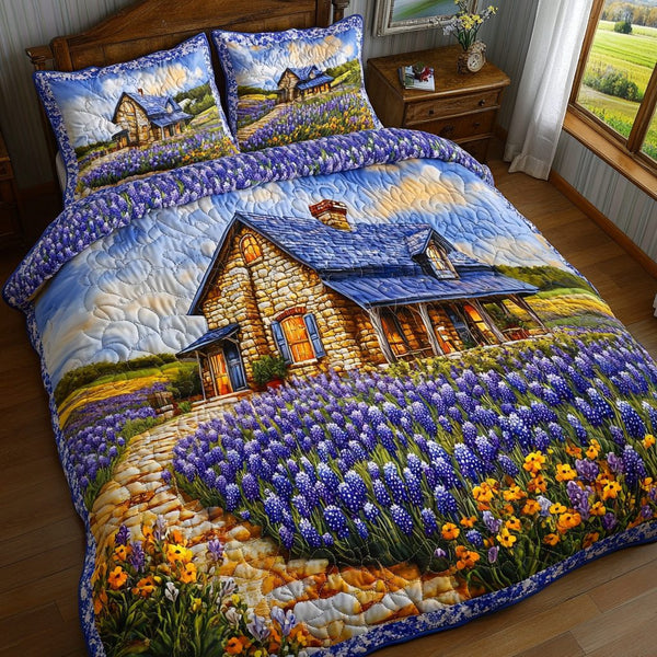Bluebonnet Dream quilted 3-piece bedding set on a made bed with two matching pillow shams