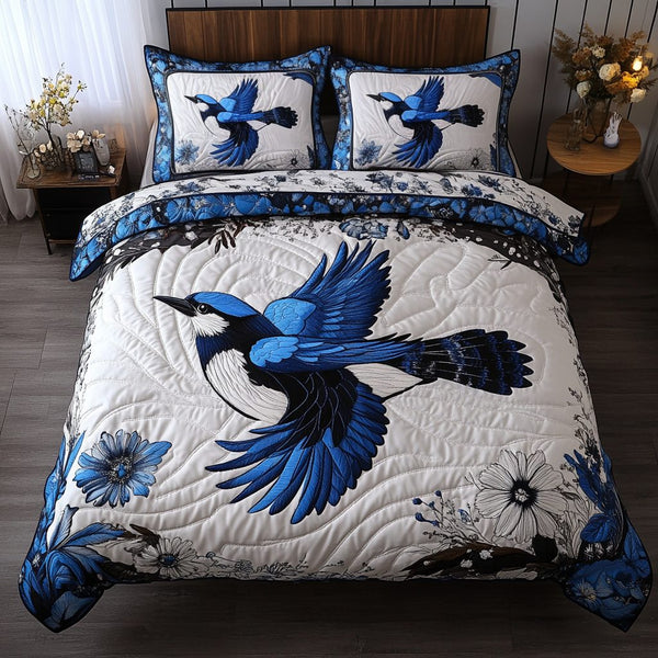 Bluejay Haven quilted 3-piece bedding set on a made bed with two matching pillow shams