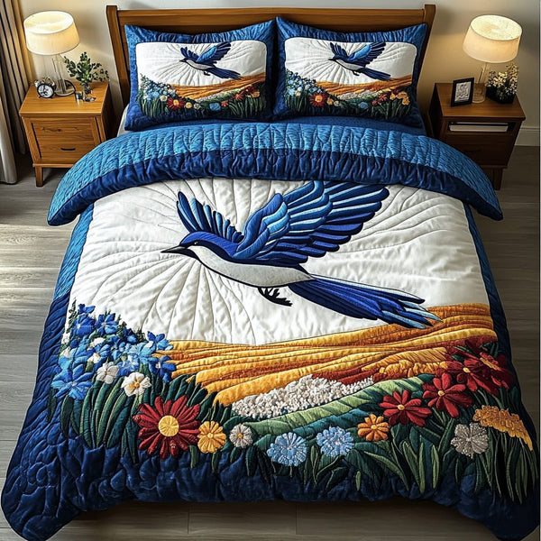 Bluejay Wings quilted 3-piece bedding set on a made bed with two matching pillow shams