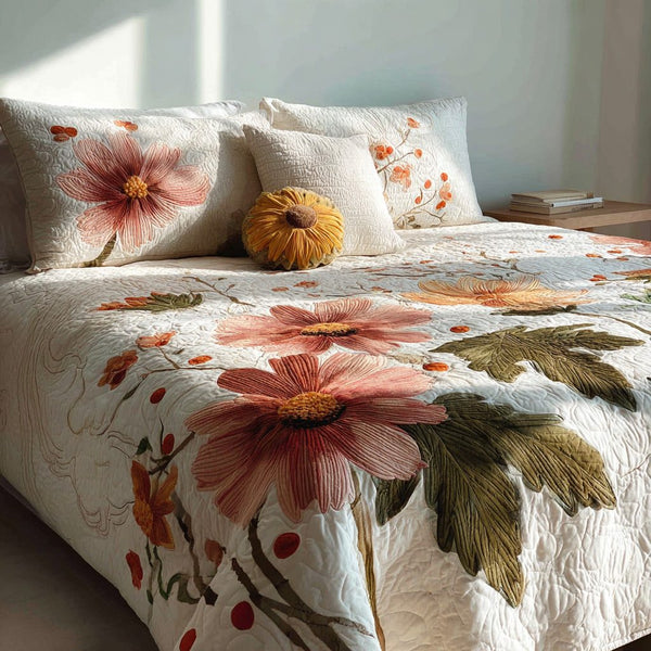 Blush Cosmos quilted 3-piece bedding set on a made bed with two matching pillow shams